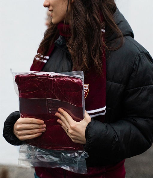 Tifosa del Torino FC con coperta granata Q8.